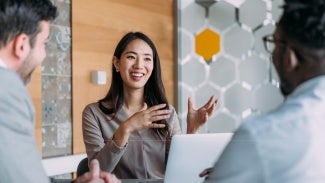 Lady working with speaking to two men