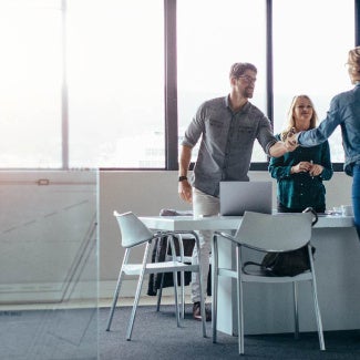 Architects shaking hands in an office
