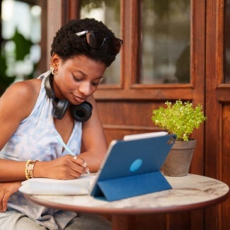 Woman on laptop taking notes