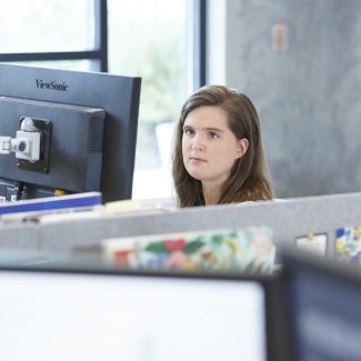 Female student at desk looking at monitor