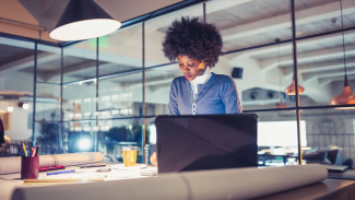 women in an open office working at a desk