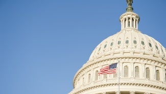 American flag waving in front of Capitol Hill 