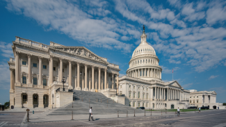 Wide angle view US Capitol with large blue sky and clouds