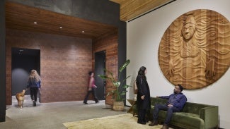 The lobby integrates artwork from Toma Villa, a Portland-raised member of the Yakama Nation. The wood carving and motifs of indigenous basketry designs welcome visitors.