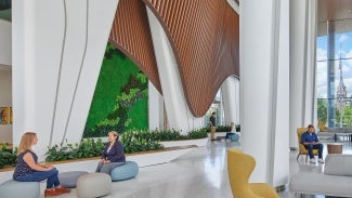 The indoor public spaces begin with a glazed winter garden that provides a hotel-like entry experience. The use of natural planting as well as warm and comforting building material such as wood soffits and textured brick reduce visitors' and patients' anxiety and provide a welcoming, clear, and convenient entry for the community.