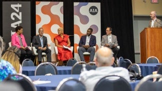 Speaker panel on stage at AIA conference on architecture & design