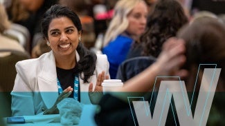 Woman smiling at conference event.