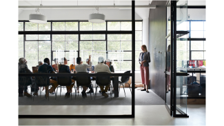 Architects meet in a board room around a table