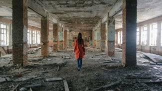 Lady in a destroyed and hazardous building