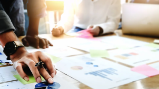 AIA member reviewing charts on their desk