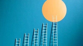 abstract image of ladders arranged by height against blue background leading up to yellow sun