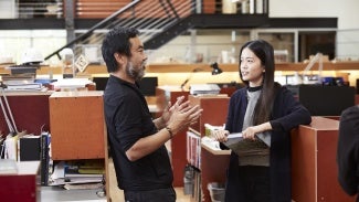 Female student learning from a male architect