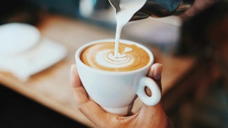 Barista pouring a nice design in a cappucino