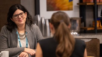 Two females speaking with one another in a business setting