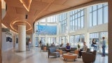 The atrium provides a view of the monitor showcasing information to adjacent levels and into the courtyard. Seating varieties provide patients and staff places to meet family or eat at the cafe.