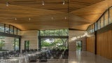 Expansive window walls beneath outstretched overhangs break down the defining lines of indoor and outdoor, bringing the grandeur of the garden landscapes into the public gathering spaces.