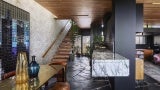 Interior of home with black floor, black column, and cedar stairs