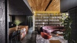 Interior of home showing a wooden bar and purple couch