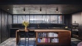 Interior of home with a wood desk serving as a book shelf