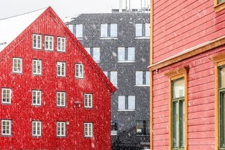 Buildings with falling snow indicating cold weather