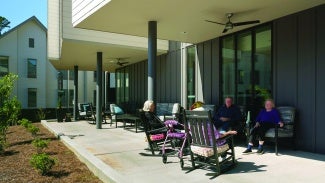 Residents visit together on the patio