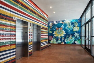 Colored tile on elevator core derived from flags of Latin American countries, mural painted by Aurelio del Muro and Marta Blair