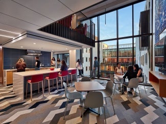Double-height student lounge space on North side.