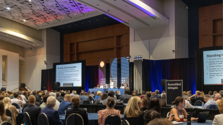 Delegates gather in a ballroom for the AIA Business meeting