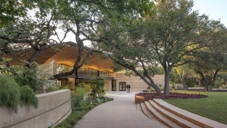 Preserving the iconic central Texas landscape, the buildings are woven through the existing vegetation avoiding canopies and protecting roots of the mature oaks inhabiting the site.