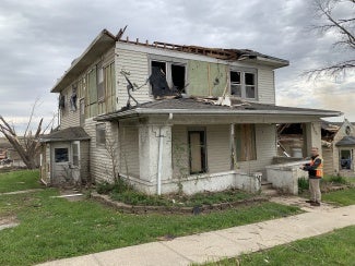 Iowa architect assessing a tornado-damaged home