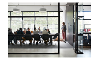 Architects meet in a board room around a table