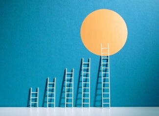 abstract image of ladders arranged by height against blue background leading up to yellow sun