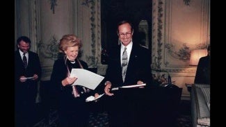 Raymond Post and Ambassador Pamela Harriman at reception in Paris