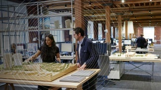 Man and woman reviewing architecture model