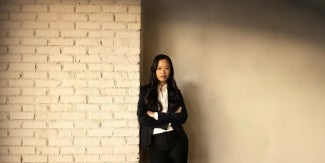 Evelyn Lee standing in front of brick wall