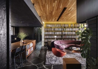 Interior of home showing a wooden bar and purple couch