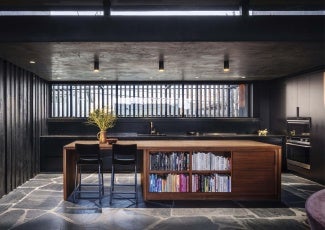 Interior of home with a wood desk serving as a book shelf