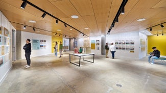 Museum attendees looking at architecture exhibit