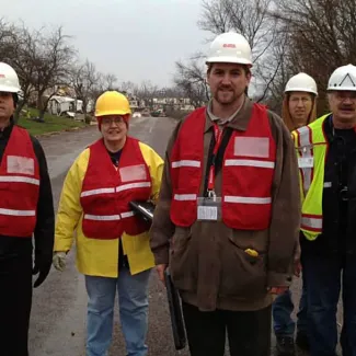 people in vests support the disaster assistance program