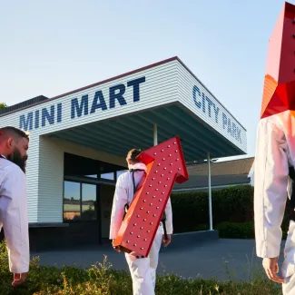 Exterior of Mini Mart City Park with people in the foreground