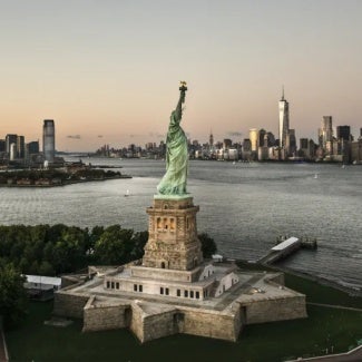 aerial photo of the statue of liberty with the city in the background