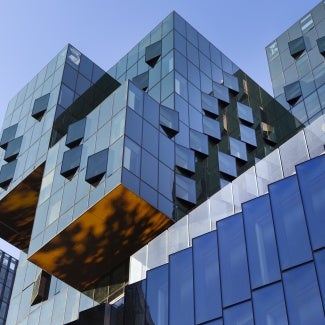 Exterior angle view of multiple styles of modern buildings against a clear sky. 