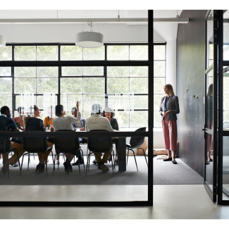 Architects meet in a board room around a table