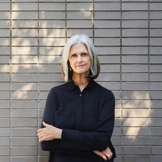 Deborah Berke in front of brick wall