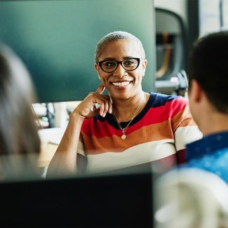 Individual in red shirt talking to an individual in blue shirt