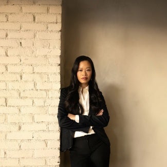 Evelyn Lee standing in front of brick wall