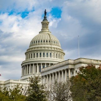 image of u.s. capitol dome with clouds in background