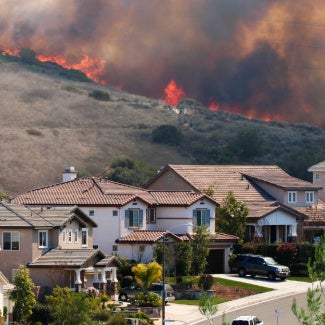 image of a wildfire and homes nearby