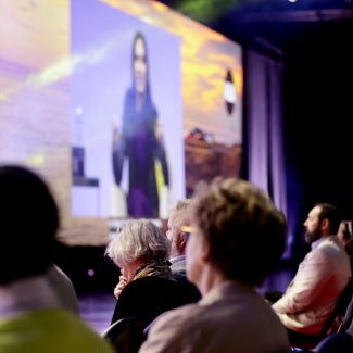 A crowd listens to a talk